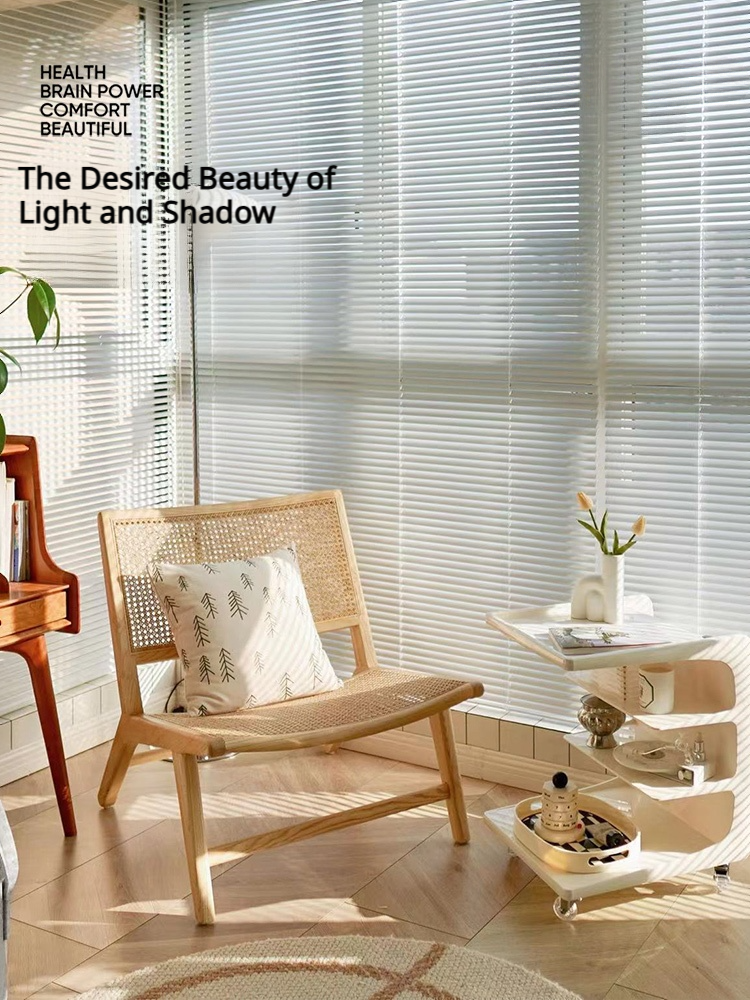 White aluminum Venetian blinds casting striped daylight across a home office