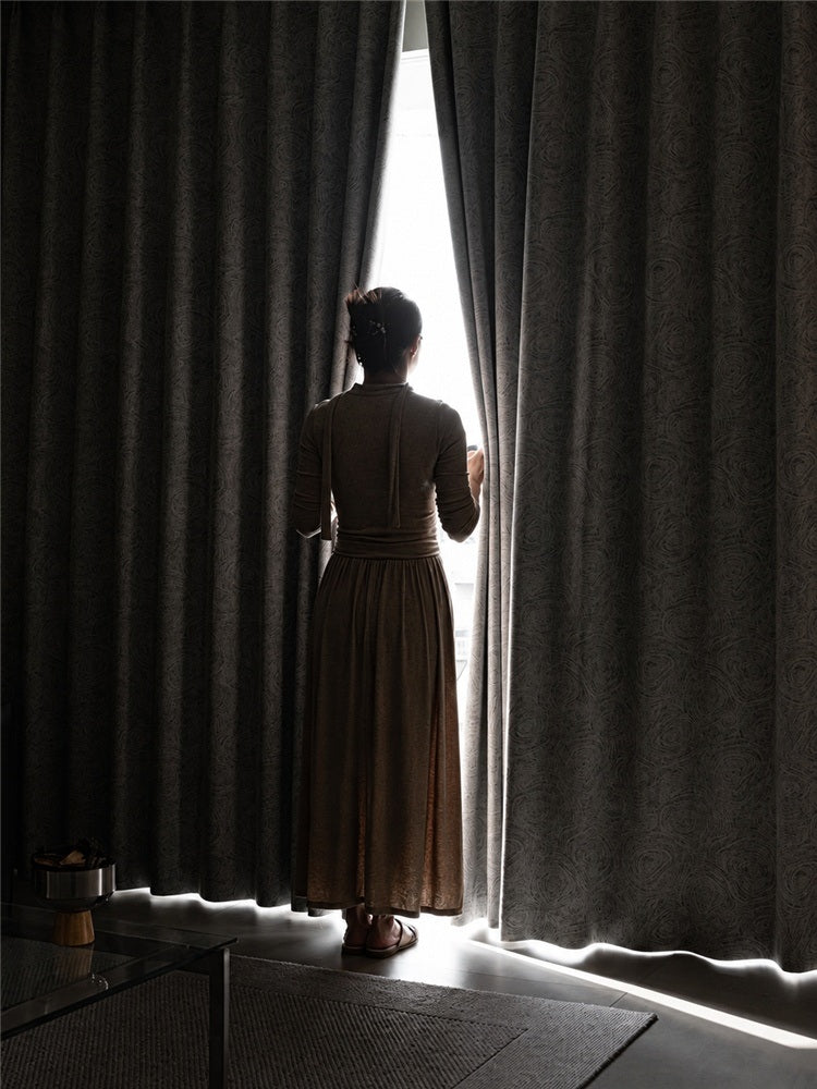 Room-darkening curtain at a window